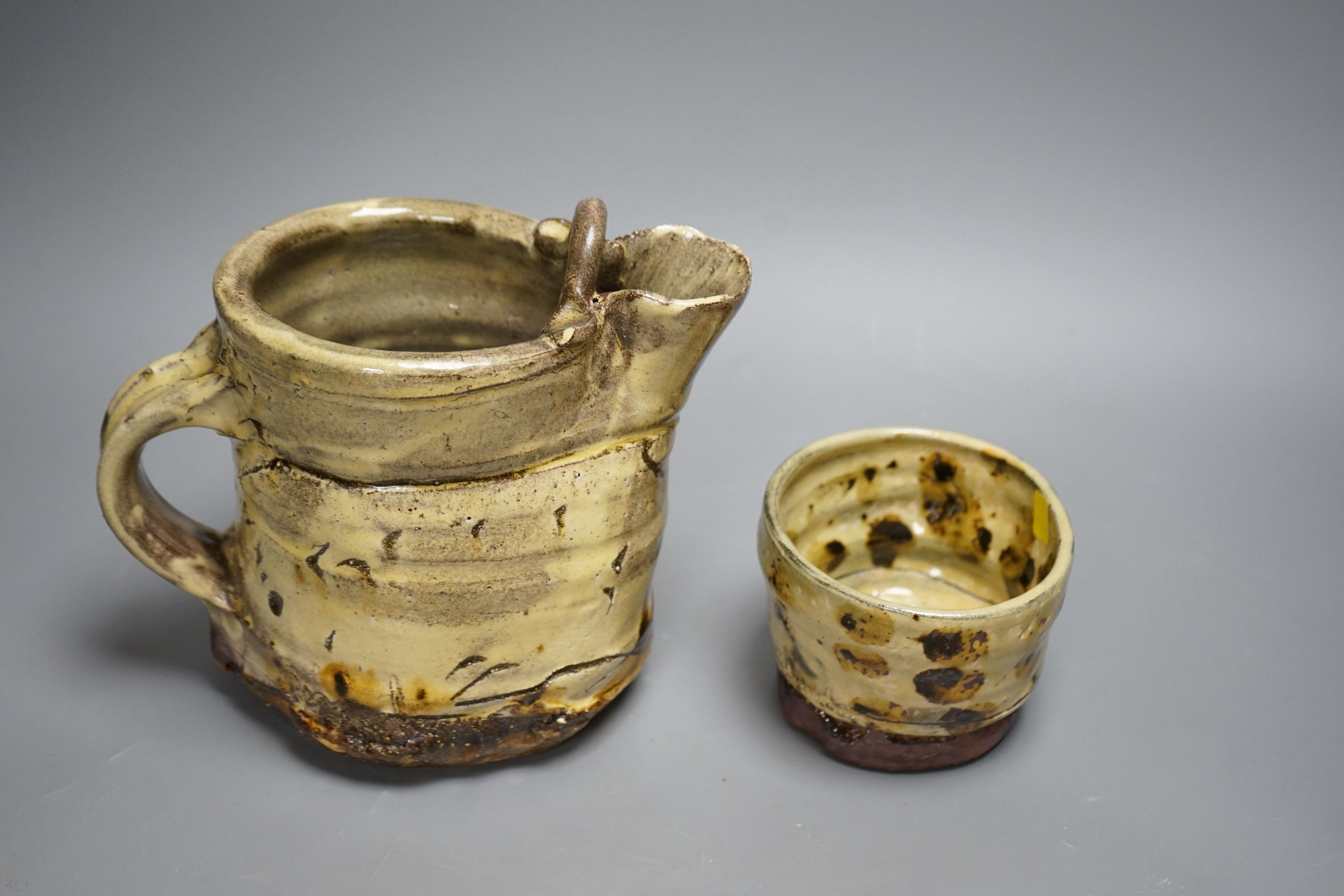 Jean-Nicolas Gérard (b.1954), a pale yellow and brown glazed earthenware jug and a similar bowl, with purchase receipt from Goldmark Gallery dated 09/04/2014, tallest 19.5cm, (2)